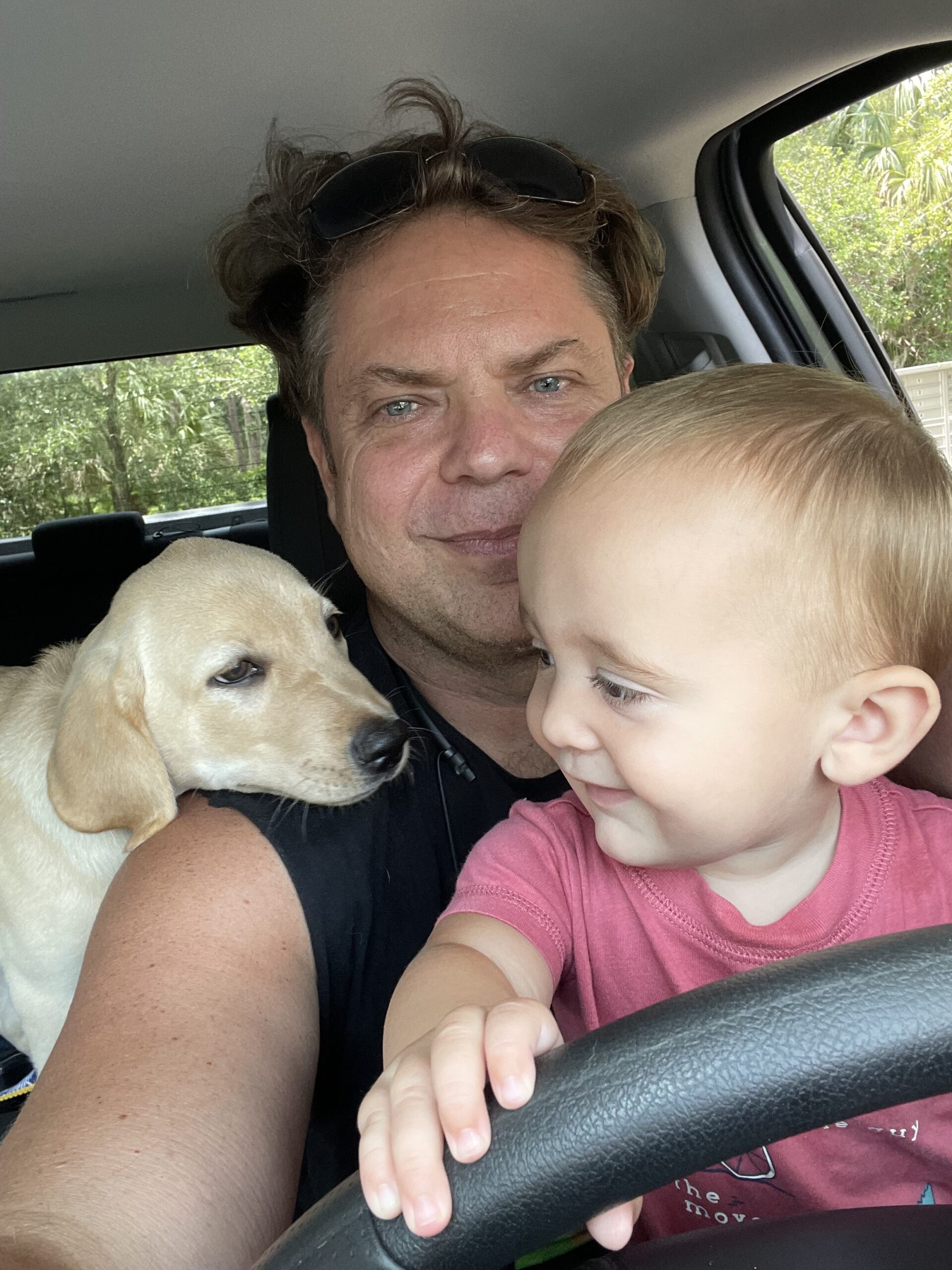 Dr. Paul Borosky with Remi, his champagne Labrador, and his grandchild, Borosky Labradors in Sanford FL
